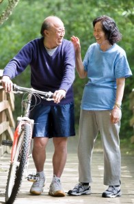 A couple senior asian talking and exercising at a park